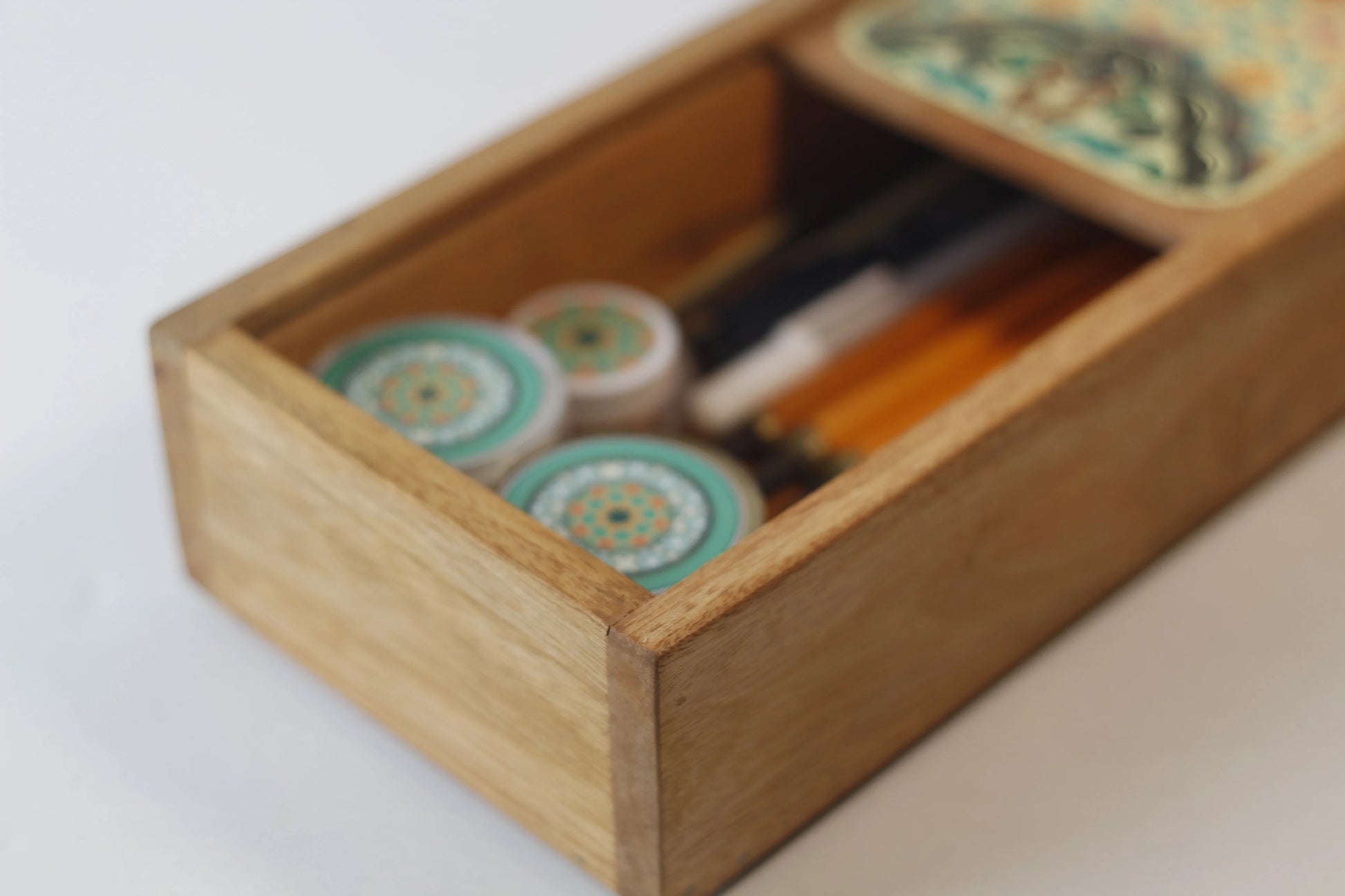 wooden box filled with calligraphy pens ink and nibs