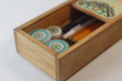 wooden box filled with calligraphy pens ink and nibs