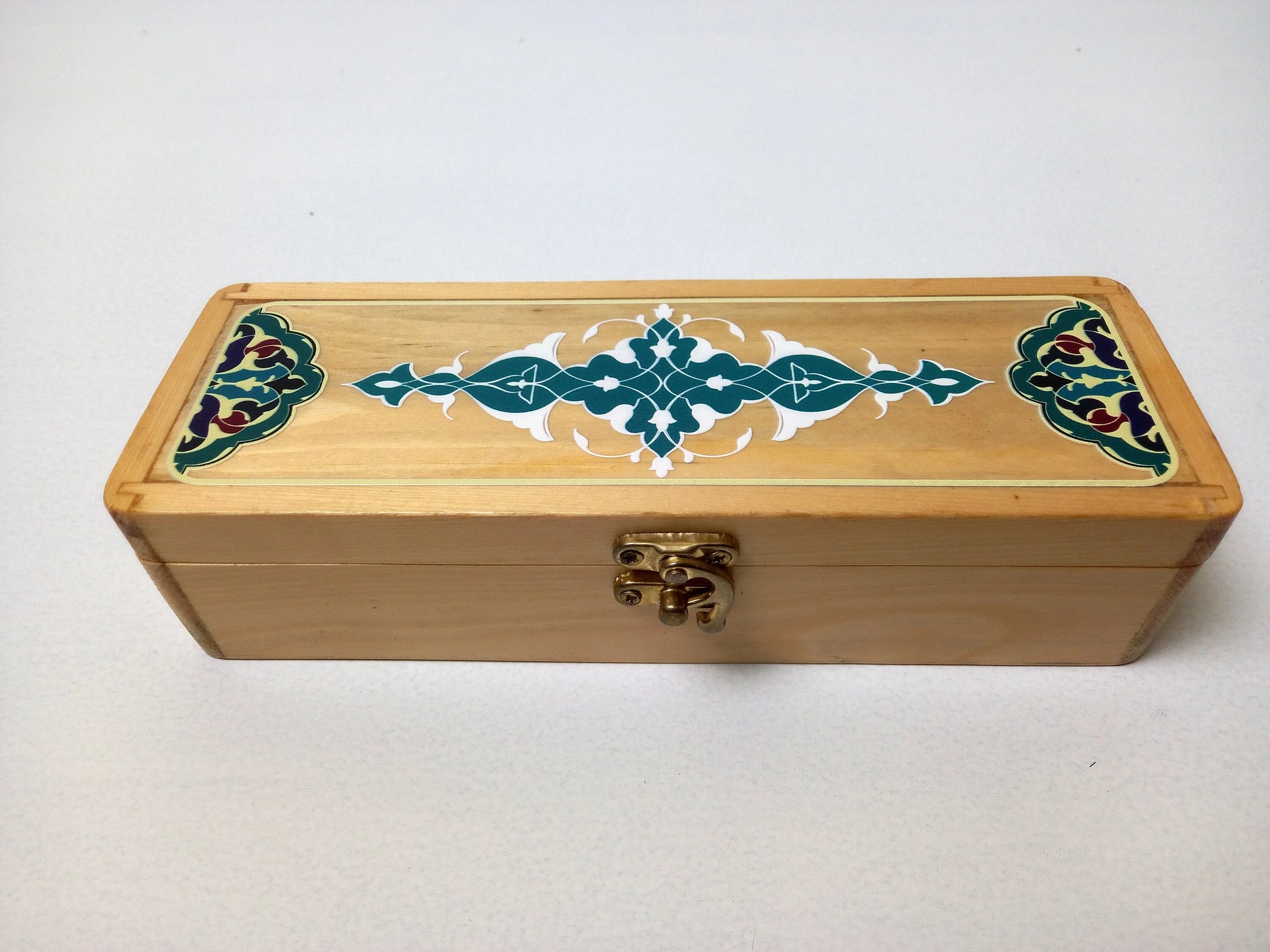 Clip lock closure mechanism on teak calligraphy box