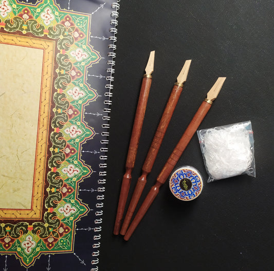 Complete calligraphy tool set overview with pens, sheets, likka and dish